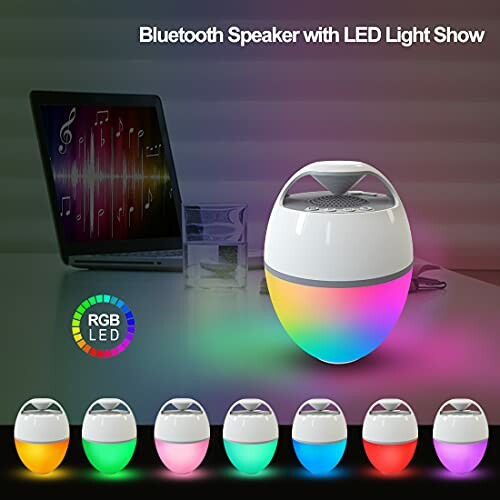 Bluetooth speaker with LED light show on a table near a laptop.