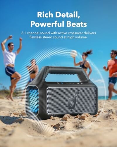 Portable speaker on a beach with people dancing in the background