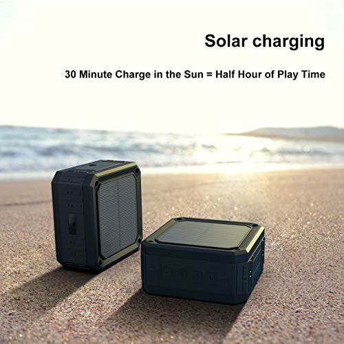 Two portable speakers with solar charging on a beach