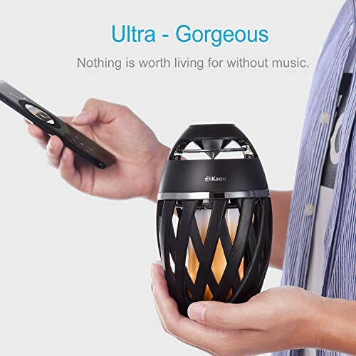 Wireless speaker with bass-enhancing design and glowing light.